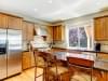 Wood classic large kitchen with granite island.